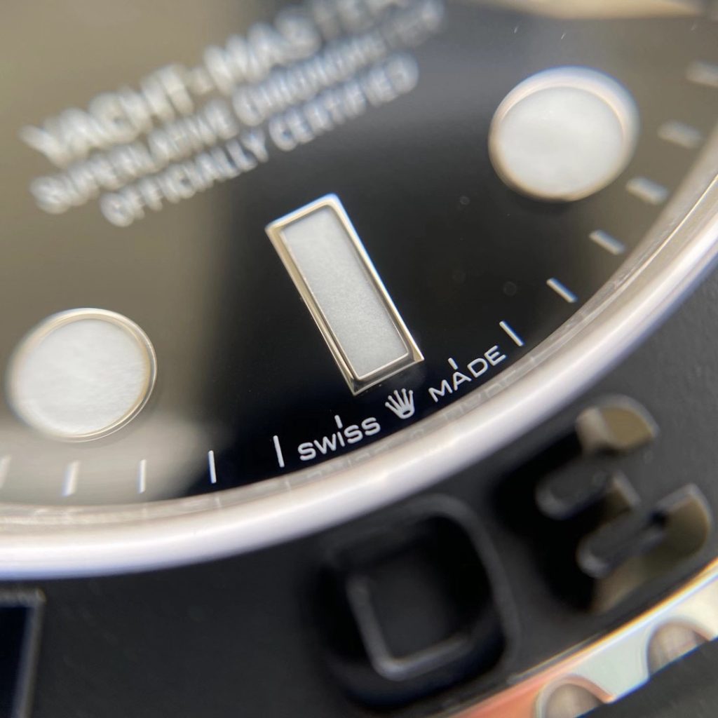 Macro view of the SWISS MADE print and coronet at the 6 o'clock position