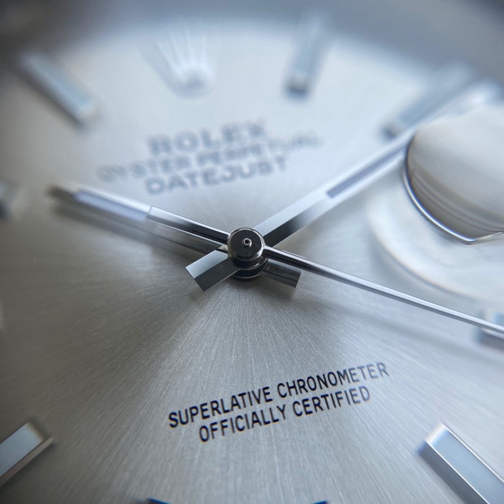 Macro view of the solid center pinion and polished hands on the VS Factory Datejust 41