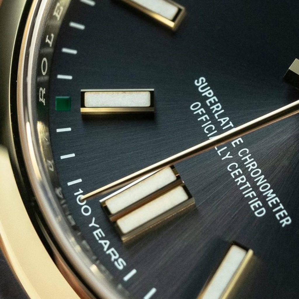 Microscopic view of the 6 o'clock minute track showing the precise '100 YEARS' centenary laser marking